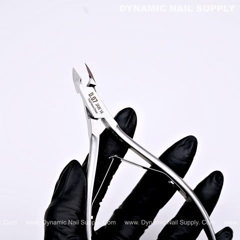 A black-gloved hand holds D07 Jaw 14 Cuticle Nippers—super fine jaw clippers with smooth spring action.