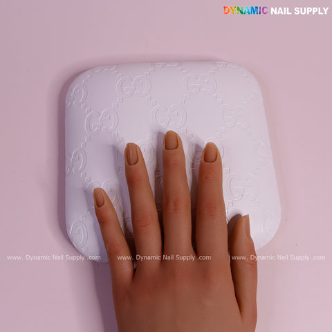 A hand model with nude nails rests on the White GC Engrave - Smooth Elbow Pad Pillow for nail techs in soft PU leather.