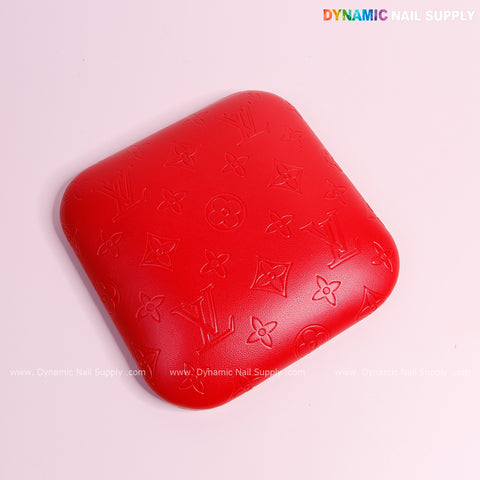 The Red LV Engrave Elbow Pad for Nail Tech offers soft PU leather support, perfect as a stylish armrest.