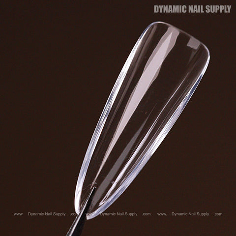 A long, clear almond full cover Soft-Gel nail tip (Natural, Pink Box) shown on black; Dynamic Nail Supply in corner.