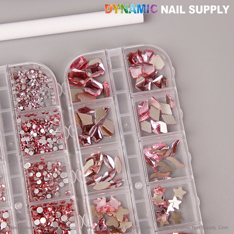 A clear organizer holds the Pink Multi Shape Size Nail Crystal Gem Rhinestone Set, by DYNAMIC NAIL SUPPLY.