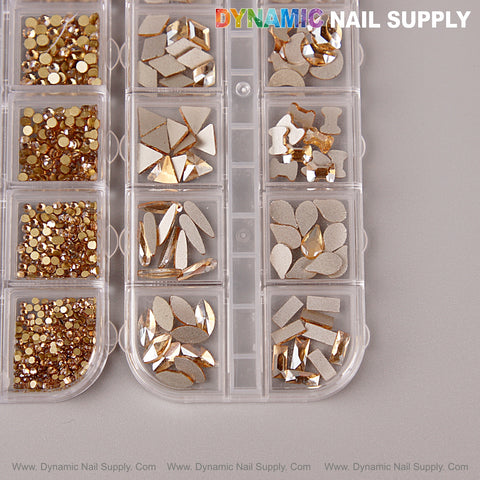 A plastic container holds the [Champagne Gold] Multi Shape Size Nail Crystal Gem Rhinestone Set, shown on a gray surface.