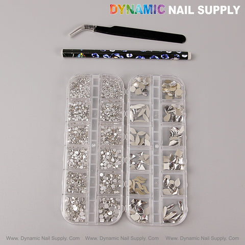 Two [Silver] Multi Shape Size Nail Crystal Gem Kits, a rhinestone picker pencil, and tweezers on gray background.