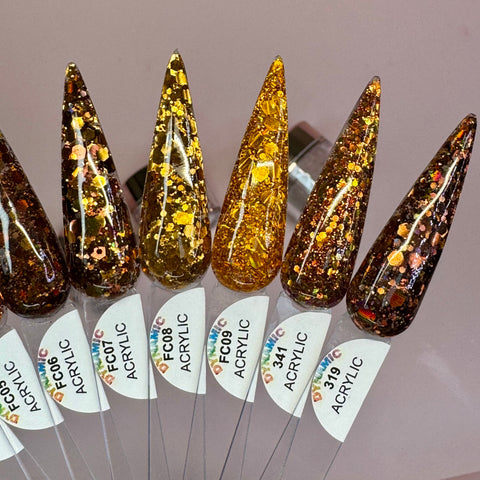 A detailed view of six elongated, pointed nail polish samples from the "Flavors Of Fall" 2024 Acrylic Powder Collection by Dynamic Nail Supply, arranged in a row to highlight glittery designs in shades of brown, gold, and bronze. These samples are enhanced with long-lasting nails technology and made from non-toxic materials. Small labels beneath each sample display identification codes on a neutral background.