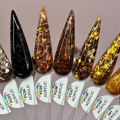 A fan display featuring eight pointed nail samples presents a variety of glitter designs ranging from black with silver sparkles to brown, gold, and orange hues with multicolored shimmer. Each sample is labeled from FC003 to FC010, with "ACRYLIC" written beneath. These are part of the "Flavors Of Fall" 2024 Acrylic Powder Collection (part 4) by Dynamic Nail Supply, expertly crafted with non-toxic acrylic powder for long-lasting nails.