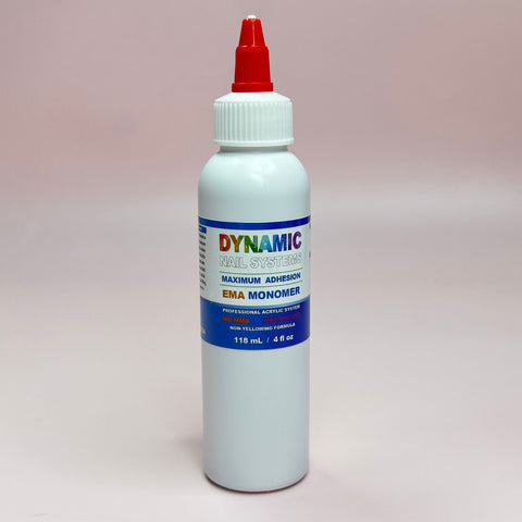 The product is a white bottle with a red nozzle cap, labeled "Dynamic Nail Supply Maximum Adhesion EMA Monomer." Ideal for your Acrylic Nail starter kit, the label showcases the brand name in rainbow colors and includes blue and white text describing its professional acrylic system. The bottle contains 118 mL or 4 fl oz of liquid.