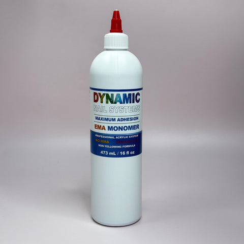 The Dynamic Nail Supply's Dynamic Nail System Monomer - EMA Nail Liquid - Healthier Nail Liquid Monomer comes in a white bottle with a red cap and vibrant labeling. It includes an advanced professional acrylic system that contains no MMA and features Color Stabilizers to ensure a non-yellowing formula. The bottle has a capacity of 473 ml or 16 fl oz.