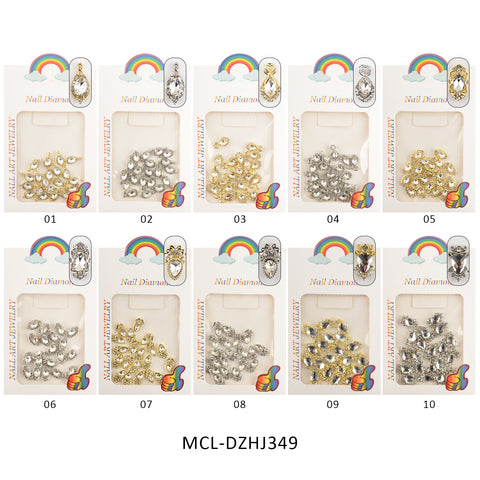 The image shows ten bags of nail art rhinestones branded as Dynamic Nail Supply's "Unique shape Charms for Nails Art Design." Each bag contains assorted shiny gems in silver or gold, ideal for nail designers looking to add distinctive shapes to their designs. The packages are embellished with a rainbow graphic and numbered from 01 to 10, arranged neatly in two rows of five. Product Code: MCL-DZHJ349.