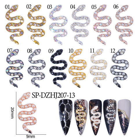Six long, pointed sample nails from Dynamic Nail Supply are adorned with a variety of embellishments, including ten smaller snake-shaped nail art charms in various colors. Each features detailed designs, with the snake shape charms highlighted at dimensions of 20mm in length and 9mm in width.