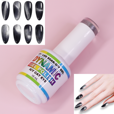 A bottle of Dynamic Nail Supply's Icy Cat Eye Gel - Reflective Magnetic Silver Shimmery Gel Polish, featuring a metallic cap, is showcased against a pink backdrop. In the top left corner, swatches highlight the dark, reflective magnetic silver polish with a cat eye effect. On the right side of the image, a hand displays long, oval nails painted with the same gel polish.