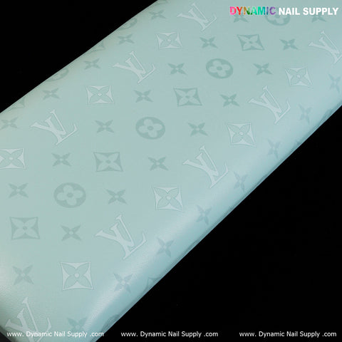 Light blue R-011 PU Leather Armrest with Pillow for manicure, featuring subtle logos on a sleek black background.
