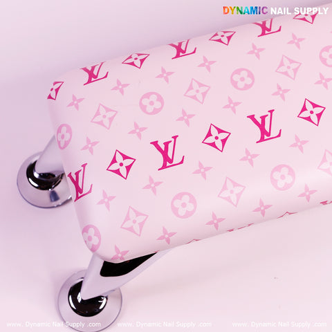 Armrest for Nail Table Pedicure Services features a pink Louis Vuitton pattern and silver legs for style and comfort.