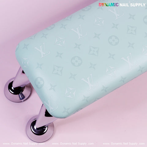 A mint green bench with a Louis Vuitton pattern, chrome legs, and an R-011 PU Leather Armrest for manicure in the corner.