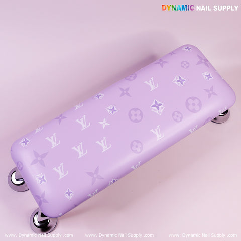 The R-004 Design Armrest for nail tables features a lavender surface with white Louis Vuitton patterns and chrome legs.