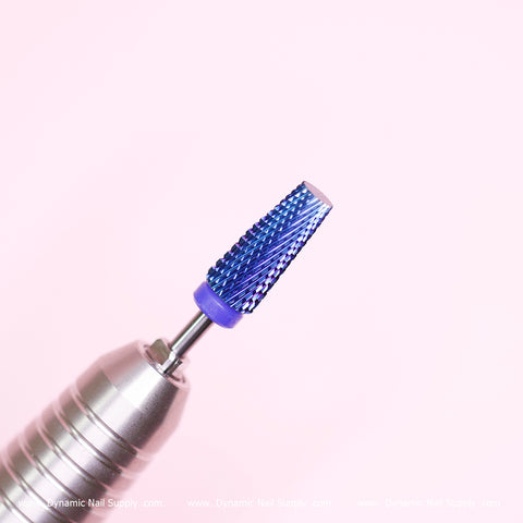 Close-up of the Tapered Titanium Drill Bit (new) Medium grit by Dynamic Nail Supply, featuring a blue, textured conical tip connected to a silver electric drill handle. Perfect for shaping and smoothing out nail beds, the image has a soft pink background with a subtle Dynamic Nail Supply watermark at the bottom.