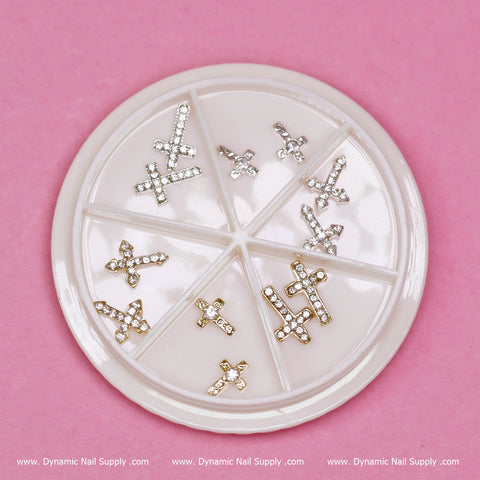 3D Crosses Charms for Nails art design (style #1), round white organizer, gold & silver, on pink background.