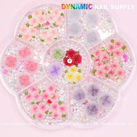 Discover the Dynamic Nail Supply's 40 piece collection of white and pink 3D rose flower charms, accented with pearls. Perfect for Valentine nail art designs, each charm is beautifully organized in compartments on a pink background.