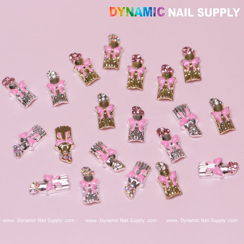 Introducing the 20 pcs Lipstick Charms with Pink Bows for Valentines Nail Art Design by Dynamic Nail Supply. These exquisite charms feature pink bows and rhinestones set against a pink background, available in elegant gold and silver finishes. The brand name, Dynamic Nail Supply, is gracefully printed at the top and bottom.