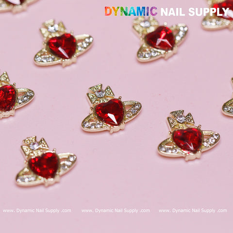 A set of 12 Vivienne Westwood Vintage Red Heart Charms, embellished with clear, round accents, is displayed on a pink surface. The top of the image showcases the brand name Dynamic Nail Supply in colorful and bold lettering, ideal for any nail art designer striving for timeless elegance.