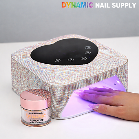 A hand under a Silver Small Rhinestone UV/LED Cordless 72W Lamp; “DYNAMIC NAIL SUPPLY” text above.