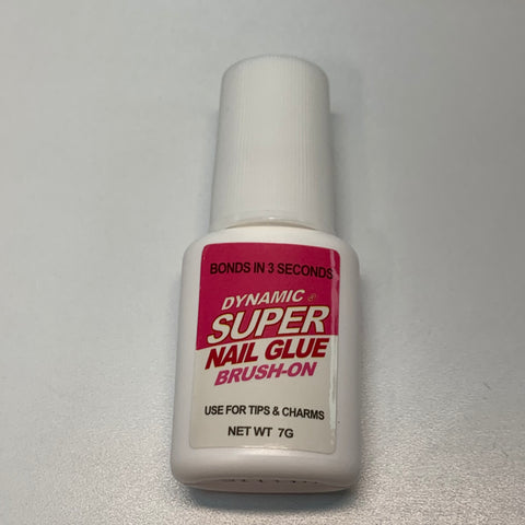 A small white bottle from the Dynamic Nail Supply's Acrylic Nail Starter Kit for professionals and beginners is showcased against a light background. It features a pink and red label that announces "Bonds in 3 seconds" and is ideal for tips & charms, making it an essential addition to any nail salon or acrylic nail kit. It weighs 7 grams and includes a secure screw-on cap.