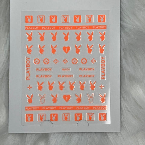 Introducing the "Logo Sticker for Nails Art Design - Md006 - Orange" by Dynamic Nail Supply, featuring peel-off sheets adorned with the iconic Playboy bunny logo, playful PLAYBOY text, hearts, and stars. These orange nail stickers are carefully arranged in rows on a transparent backing and tastefully set against a soft, light gray fur surface.