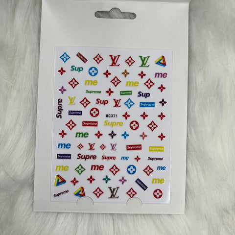 The Logo Sticker for nails art design -WG371 by Dynamic Nail Supply features a vibrant sheet of small, colorful stickers adorned with various logos and text such as "Supreme," "me," and a repeating LV pattern. In hues of red, blue, green, and yellow set against a white textured background, these stickers are perfect for adding flair to notebooks or nail designs.