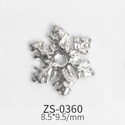 These snowflake charms, ideal for enhancing nail designs, feature intricate detailing and a central hole. Measuring 8.5 by 9.5 millimeters, they are part of the Dynamic Nail Supply collection and come in sets of 24 pieces. The product code ZS-0360 is displayed below on a plain white background.