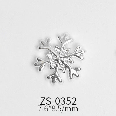 Displayed on a white background, a small, silver snowflake-shaped metal object resembles unique nail shapes. Below it, the text reads ZS-0352 and 7.6*8.5/mm, indicating its model number and dimensions. The intricate design is from the "24pcs Snowflake Charms for Winter and Christmas nails art design" set by Dynamic Nail Supply.