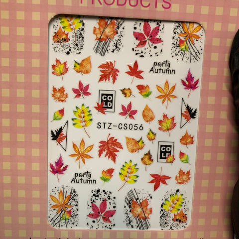 The Fall Nail Designs Stickers for Fall Season 2021 by Dynamic Nail Supply feature a collection of autumn-themed designs, such as vibrant leaves, acorns, and abstract patterns in shades of red, orange, yellow, and green. The words "party" and "Autumn" are elegantly placed among the designs on a pink checkered background—ideal for creating stunning fall nail art.