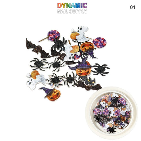 Dynamic Nail Supply presents their Halloween Sequins for Nail Art Design, featuring a spooky assortment of bats, spiders, white ghosts, and pumpkins wearing purple witch hats. A small dish displays this enchanting collection.