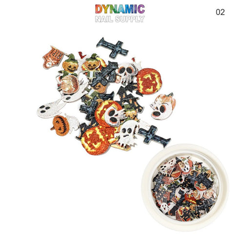 Introducing the Halloween Sequins for Nail Art Design by Dynamic Nail Supply. This collection features vibrant sequins shaped like pumpkins, skulls, ghosts, and crosses. The colorful and glittery designs are beautifully scattered around a small bowl, with "DYNAMIC NAIL SUPPLY" prominently displayed at the top in colorful letters.