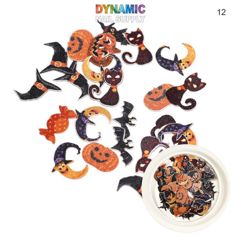 A small container holds Halloween Sequins for Nail Art Design, featuring a variety of festive elements such as black cats, orange pumpkins, bats, and crescent moons with a sparkly finish. The Dynamic Nail Supply logo is prominently displayed at the top left.