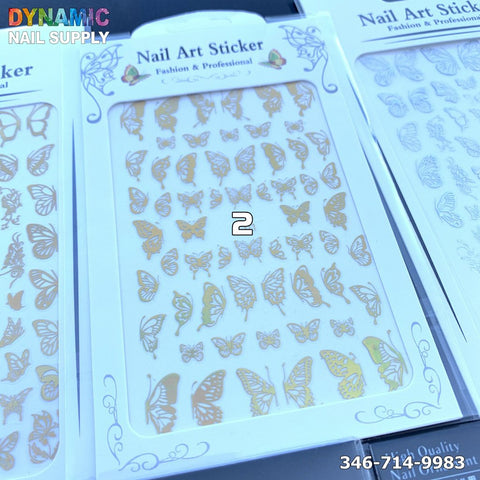 A package of Holographic Metallic Butterfly Sticker for Nail Art Design is displayed on a store shelf. The packaging features decorative borders and is labeled with Nail Art Sticker and Fashion & Professional. The name Dynamic Nail Supply, along with a contact number, is visible in the corner.