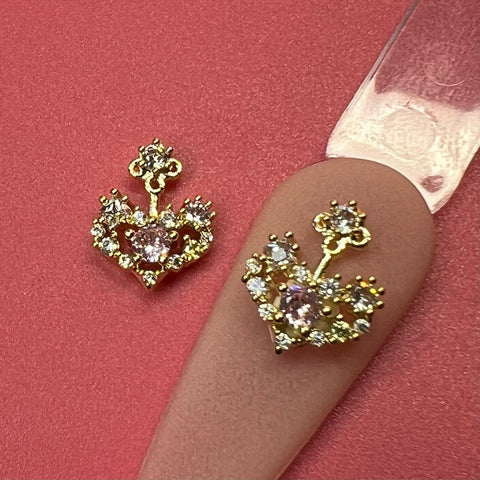 2 pcs 3D heart-shape nail charms with pink rhinestones, styled by Dynamic Nail Supply.