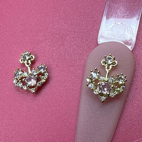 Gold heart earrings with pink and clear stones, shown next to 2 pcs 3D Heart-shape Charm for Nails Art Design (Pink Rhinestones).