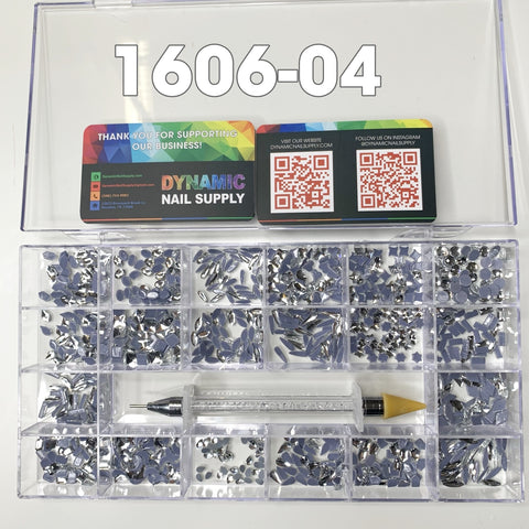 The Dynamic Nail Supply organizer box, showcasing SKU: [1606-04], features various compartments filled with 1000 pieces of silver crystal rhinestones in 20 different shapes, each containing 50 pieces. A picker pen sporting a yellow tip is nestled inside. The lid is adorned with two colorful business cards bearing QR codes, an ideal setup for nail art design enthusiasts.