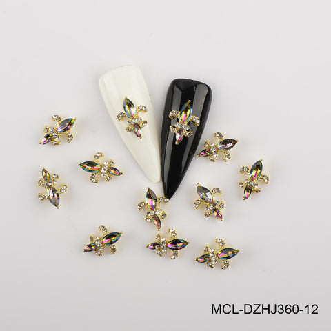Twelve Saint Fleur De Lis charms from Dynamic Nail Supply surround white and black nail samples.