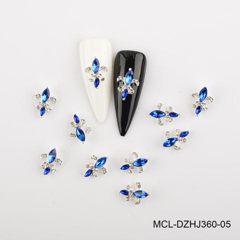 12-color Saint Fleur De Lis charms (20pcs) from Dynamic Nail Supply shown on black and white nail art swatches.