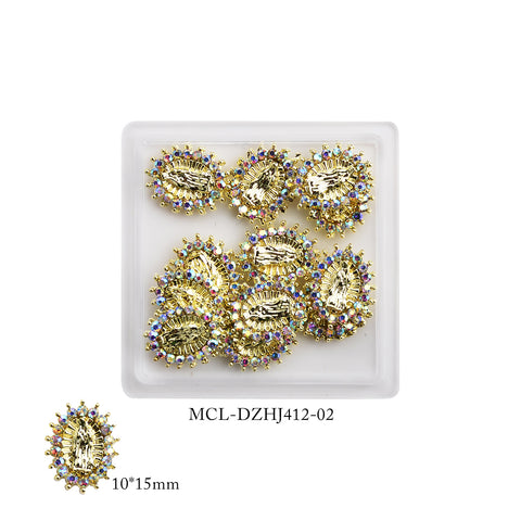 Dynamic Nail Supply's collection includes a square white tray containing twelve intricate Virgin Mary charms, ideal for religious nail designs. Each charm boasts a central leaf pattern and is adorned with colorful gems around the edges, measuring 10x15mm in size – Product Code: MCL-DZHJ412-02.