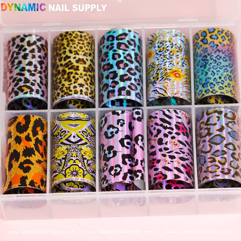 Introducing the Nail Art Design Foils - Animal Skin by Dynamic Nail Supply. This collection features twelve stunning design foils with animal skin prints, including vibrant leopard, tiger, and zebra patterns in an array of colors such as pink, gold, purple, and blue. The foils come neatly organized in a transparent case, with the brand name Dynamic Nail Supply prominently displayed at the top.