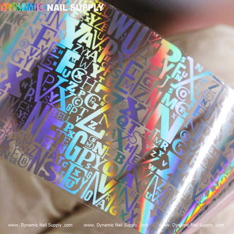The Nail Art Design Foils - Letters Style by Dynamic Nail Supply features an alphabet pattern with shiny letters in various fonts and sizes, ideal for nail art enthusiasts. The foil reflects rainbow colors and includes the brand name, Dynamic Nail Supply, repeatedly printed in small white text at the bottom, adding a chic touch to your designs.