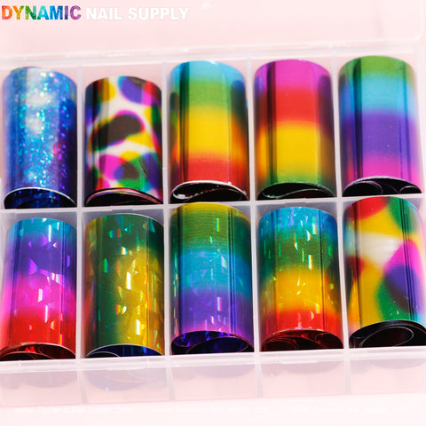 A plastic organizer from Dynamic Nail Supply includes ten rolls of *Nail Art Design Foils - Colorful*, showcasing vibrant patterns such as stripes, holographic effects, rainbow gradients, and geometric shapes, with the brand's name elegantly displayed at the top in multicolored text.