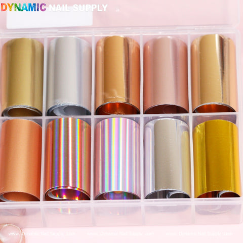 A display box features twelve vibrant Nail Art Design Foils - Metallic Style by Dynamic Nail Supply, showcasing an array of colors and finishes such as metallic silver, gold, and iridescent rainbow. Ideal for nail art projects, these foils come rolled neatly for easy use. The brand name, Dynamic Nail Supply, is prominently displayed at the top of the image.