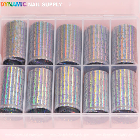 Displayed is a clear plastic organizer containing ten rolls of the "Nail Art Design Foils - Animal Skin Holographic" from Dynamic Nail Supply. The design foils have a textured, reflective surface with rainbow-like colors. At the top of the organizer, you can see the Dynamic Nail Supply branding in colorful letters.