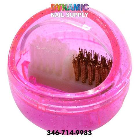 The MJ2170 Nail Drill Brush, a portable cleaning accessory from Dynamic Nail Supply, features a pink, round plastic container that holds dual-sided brush heads—one side with white bristles and the other with metal bristles. The colorful brand name, Dynamic Nail Supply, is displayed above the container, while the contact number 346-714-9983 is located at the bottom.