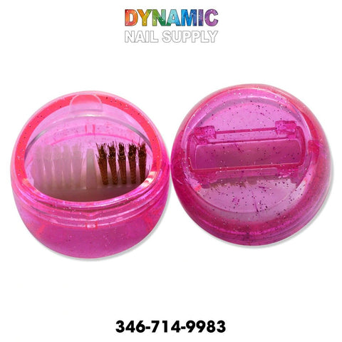 Displayed are two MJ2170 Nail Drill Brush Portable Cleaning Accessory containers by Dynamic Nail Supply, both round and pink with glitter. One container is open to show the small nail drill brush inside, making it the ideal portable cleaning tool. The other remains closed. Above the products, "Dynamic Nail Supply" is stylishly written in colorful letters, accompanied by their contact number, 346-714-9983, on a white backdrop.