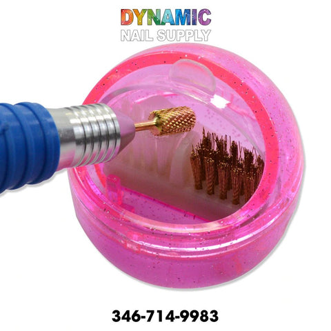 Several gold nail drill bits, ideal for precision work with the MJ2170 Nail Drill Brush Portable Cleaning Accessory, are stored in a pink container. The brand name "Dynamic Nail Supply" is prominently displayed in colorful letters at the top, while their contact number, 346-714-9983, is listed in black at the bottom.