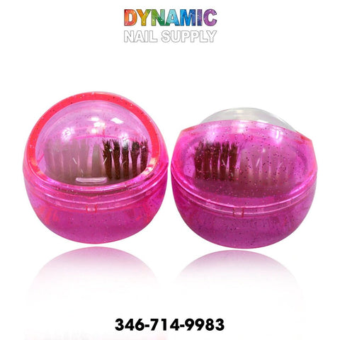 On a white background, two round transparent containers for nail brushes display embedded glitter, sparkling brilliantly. These portable cleaning accessories reveal visible bristles inside. Above them, "Dynamic Nail Supply" is prominently displayed in colorful text along with the number: 346-714-9983. The MJ2170 Nail Drill Brush Portable Cleaning Accessory is available now.