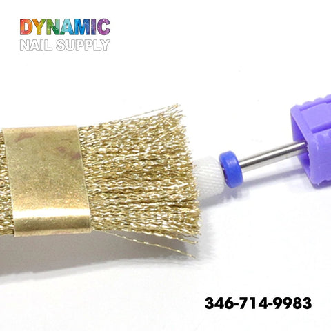 A close-up image showcases the QH0600 Copper Wire Brush for Nail Drill Bit Cleaning, featuring a metallic bristle brush perfect for cleaning. The brush is adorned with a gold band at its base and partially covered by a purple cap. "Dynamic Nail Supply" is displayed in the top left corner, while the phone number 346-714-9983 is positioned in the bottom right.